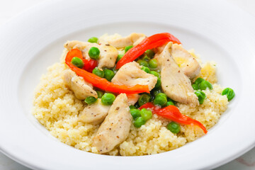 poultry meat with green peas, red pepper and couscous