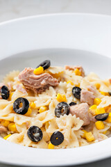 pasta farfalle with tuna, black olives and corn