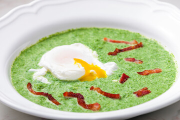 creamy spinach soup with poached egg and bacon
