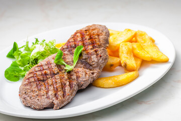 beef steak with homemade french fries and vegetable salad