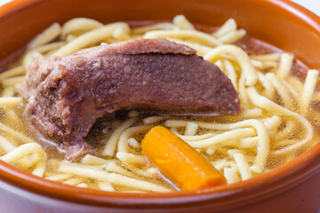 beef bouillon with carrot and noodles