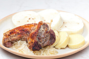 pork meat on cumin with cabbage and dumplings