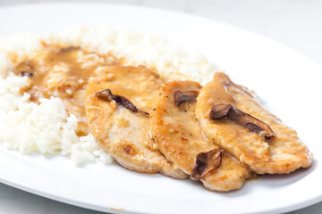 poultry meat with mushroom sauce and rice