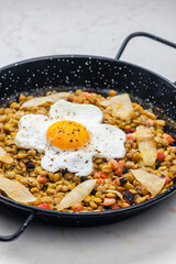 lentils with smoked meat and onion served with fried egg