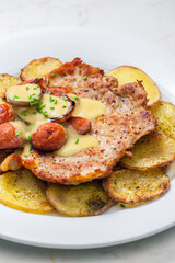 roasted pork meat with sausage, mustard sauce and roasted potatoes