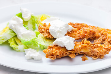 fried chicken in cornflakes with lettuce and garlic dip