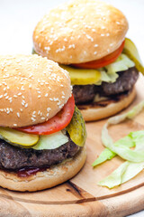 homemade hamburger with pickled cucumber and tomato