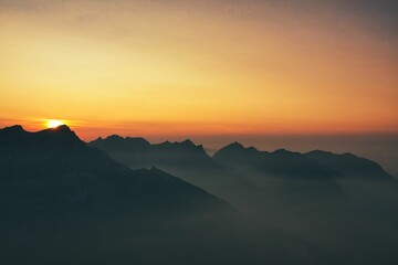mountain silhouette at night during colorful sunset time in the swiss alps mountains