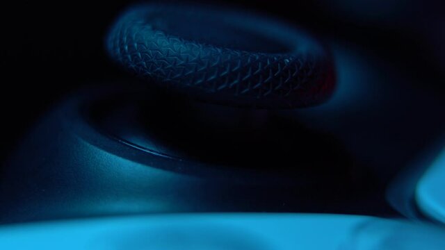 Next generation white video game controller isolated on black background with revealing lights. Macro close up. Selective focus.