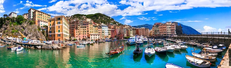 Fototapeta na wymiar Camogli - beautiful colorful town in Liguria, panorama with traditional fishing boats .popular tourist destination in Italy