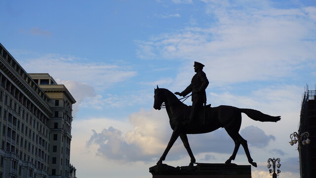 silhouette of a street sculpture a man on a horse evening city city buildings moscow street silhouettes architecture