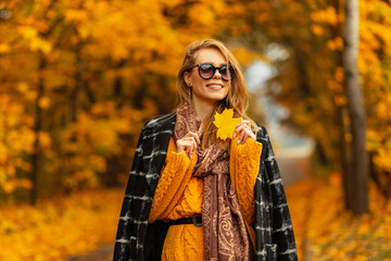 Happy Pretty Autumn Woman with Autumn Yellow Leaves on Fall Nature Background