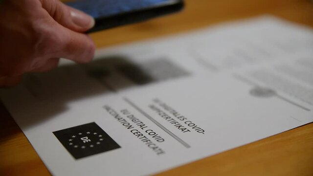 Person scanning the QR code of a covid 19 certificate. Scanning the coronavirus green pass.