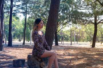 girl sitting on a log