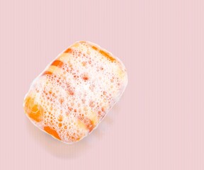 Face cleansing mousse sample. Foam bubbles on nude background.