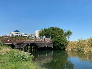 Fototapeta na wymiar Small Wooden Bridge Over River