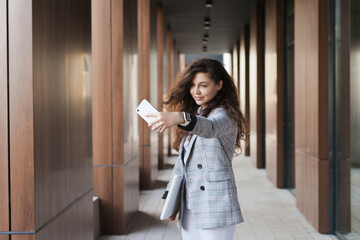 millennial woman video chatting on the mobile phone in the city