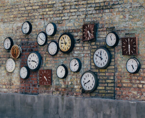 Vintage clocks on old brick wall.