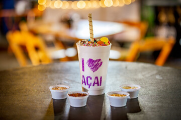 Brazilian açaí frozen in a styrofoam cup with condensed milk and candies. For açaí Lovers.