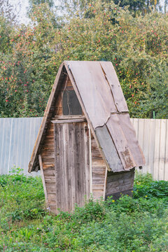 Wooden ancient toilet cabin by rthe private village house.
