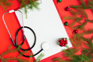 Medical Christmas concept with stethoscope, blank clipboard with white paper