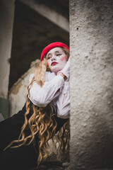 The girl with makeup of the mime. improvisation. Suit for Halloween. mime shows different emotions. Sad clown