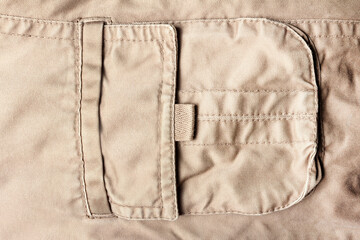 Texture backdrop photo of beige colored denim cloth pocket.