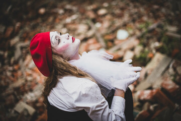 The girl with makeup of the mime. improvisation. Suit for Halloween. mime shows different emotions. Sad clown