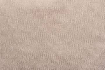 Fototapeta na wymiar Texture backdrop photo of beige colored denim cloth.