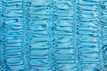 Texture backdrop photo of blue colored frill dress cloth fabric.
