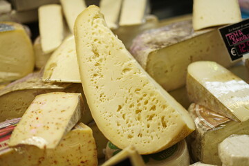 Caciocavallo, handmade semi-hard Italian cheese for sale in a cheese shop. Selective focus