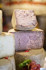 Pecorino, handmade semi-hard Italian cheese for sale in a cheese shop. Selective focus