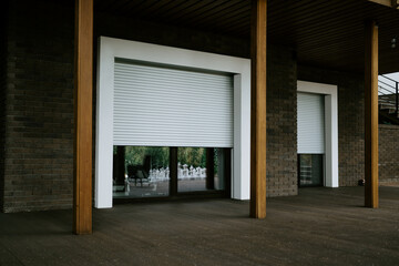 Metal roller blinds. Elegant wooden home terrace with balcony. doors from bathroom and bedroom....