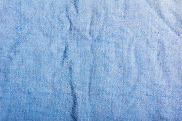 Texture backdrop photo of worn blue colored cotton cloth.