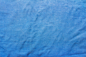 Texture backdrop photo of worn blue colored cotton cloth.