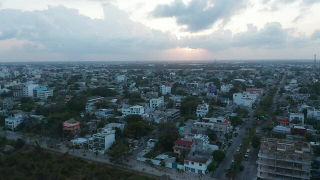 Aerial cityscape of Playa del Carmen, Mexico. Flying above multistorey buildings, hotels and residential area
