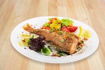 Traditional food tasty fish with vegetables on a plate