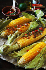 Baked corn with lime chili sauce. Grilled corn.