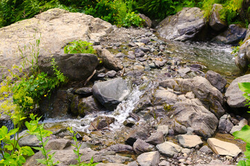 Small waterfall in the mountains in summer