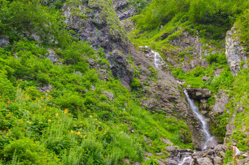 Small waterfall in the mountains in summer