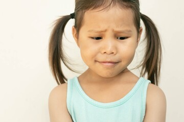 A shy worried little girl portrait. Anxiety and stress in children.