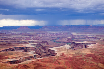 Fototapeta na wymiar A storm approaches Canyonlands National Park in Utah as the Colorado River slowly cuts deeper into the canyon, as seen from one of the overlooks.