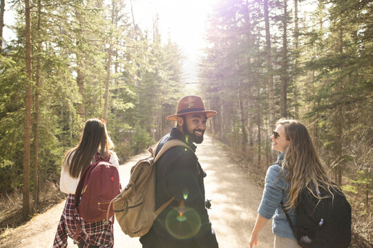 Friends walking through forest