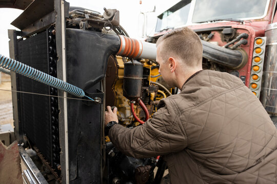 Male Farmer Fixing Semi Truck Engine