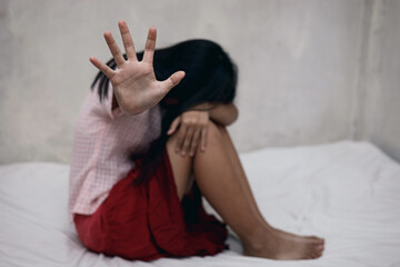 Woman showing her hand for stop sexual harassment and violence against women on  bed room.