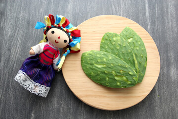 Fresh raw green nopales without bones ready to cook Mexican food on a wooden chopping board with...