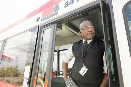 Portrait Thoughtful Male Bus Driver In Doorway