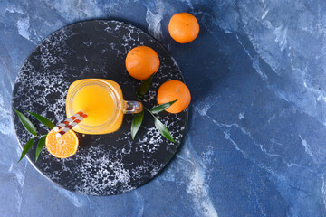 Fototapeta na wymiar Mason jar with tasty mandarin juice on color background