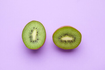 Pieces of fresh kiwi fruit on color background