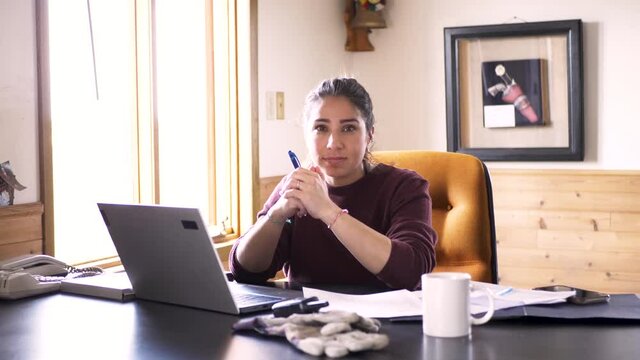 Portrait Confident Female Farmer Working At Laptop In Office